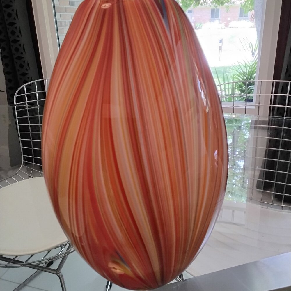 Vase hand blown shades of orange, cream, a few blues and greens nice heavy weigh